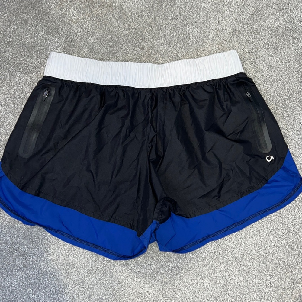 Blue, black, and white shorts with double pockets.